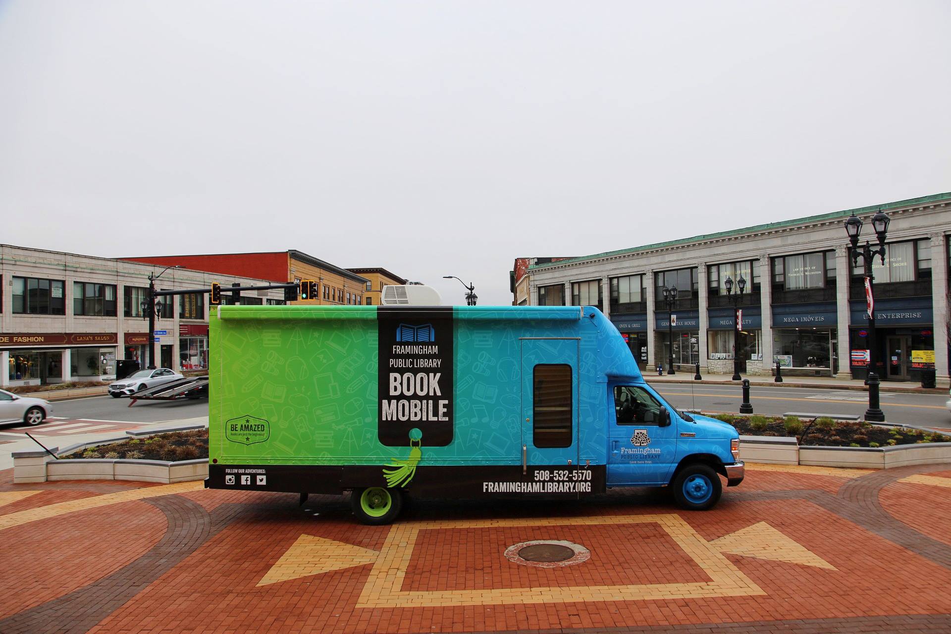 Framingham bookmobile parked on display in plaza in front of City Hall.